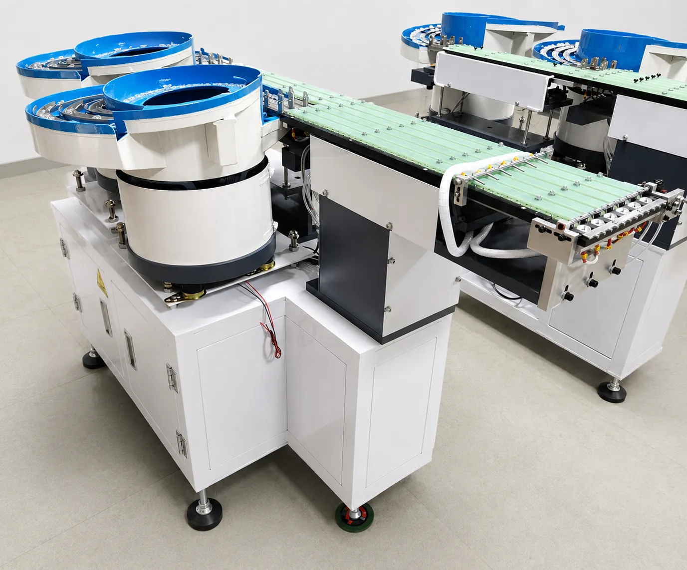 Two DPS-2 lens feeders with their green discharge tracks running side by side