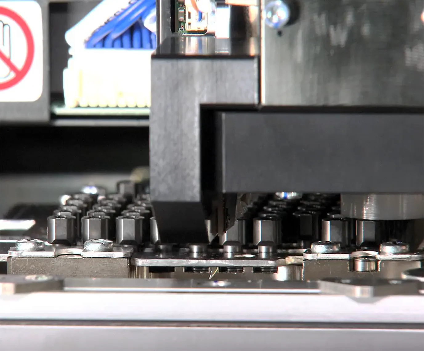 Close-up of the placement nozzle assembly and nozzle station inside a Yamaha mounter
